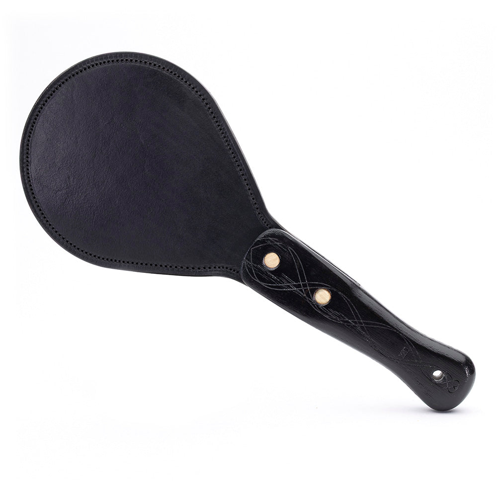 Black leather paddle with handle on a white background